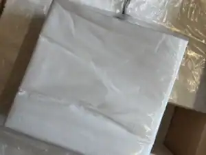 Stack of white paper napkins in box