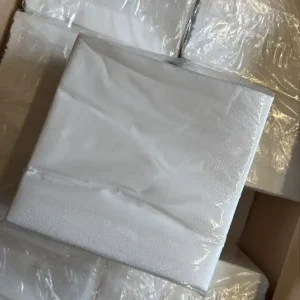 Stack of white paper napkins in box